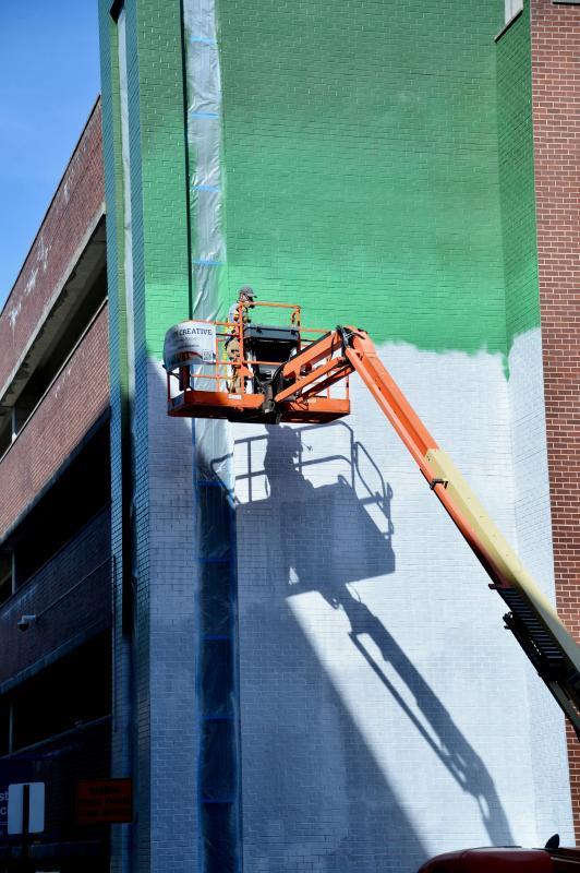 Muralist Christian Stanley at work in downtown Hagerstown